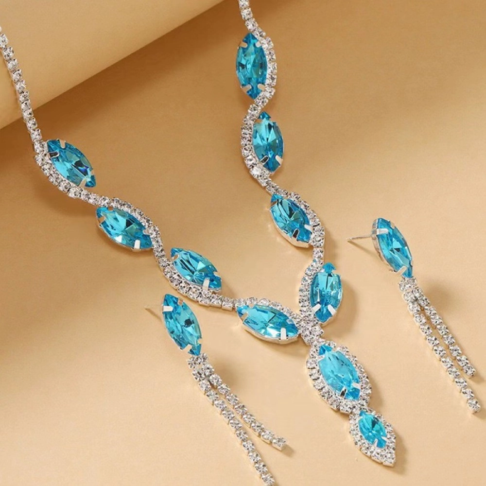 Close-up of an aqua-blue marquise stone necklace with clear crystal tassel earrings