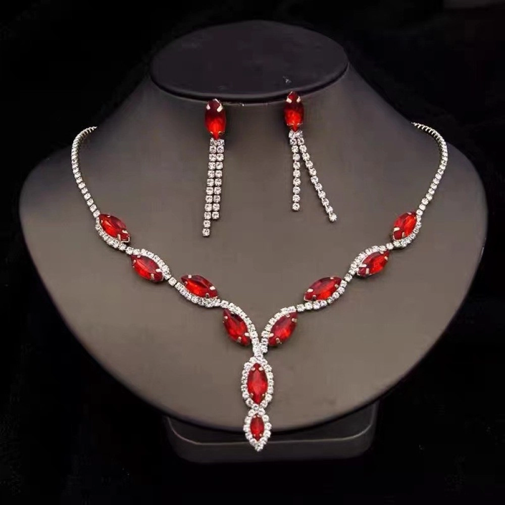 Red marquise-cut stone necklace with matching long drop earrings on a display bust